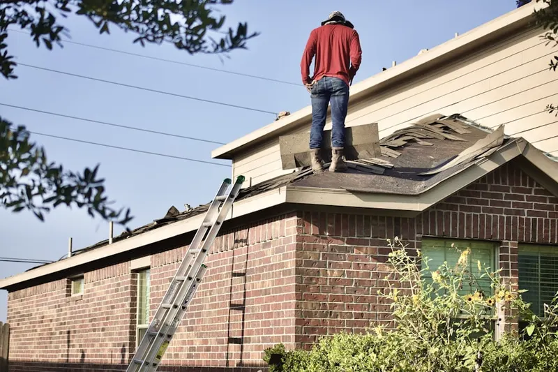 Professional roofer working on a residential roof in Ladiesburg